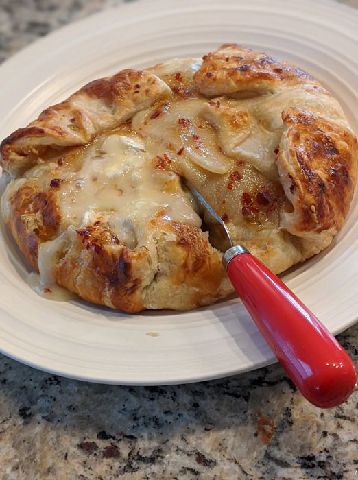 Golden puff pastry wrapped around baked brie and RedGold