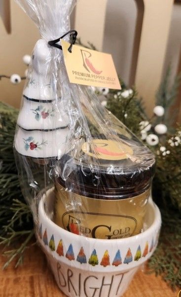 A RedGold jar in a holiday crock with a ceramic Christmas-tree spreader